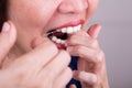 Series of Asian woman flossing teeth with oral floss