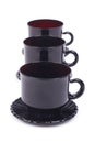 A series of black glass cups and saucers Royalty Free Stock Photo