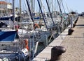 A series of boats moored in the port of Pesaro in front of the mooring bollards on the pier Marche, Italy Royalty Free Stock Photo