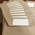 A series of brown craft paper envelopes with white rectangular labels are neatly Royalty Free Stock Photo