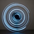 A series of concentric, glowing blue light trails form circular patterns against a dark Royalty Free Stock Photo