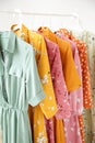 A series of fashion women`s dresses on hangers in a white cupboard for summer and spring Royalty Free Stock Photo