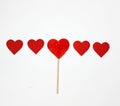 A series of five hearts, among them a candy in the shape of a he Royalty Free Stock Photo