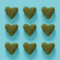 Series of green moss hearts on blue