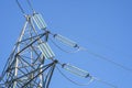 Electrical insulator on a power tower on blue sky