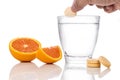 Series of orange flavored vitamin c effervescent tablet dropped and dissolve in glass of water Royalty Free Stock Photo