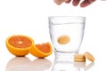 Series of orange flavored vitamin c effervescent tablet dropped and dissolve in glass of water Royalty Free Stock Photo