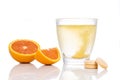 Series of orange flavored vitamin c effervescent tablet dropped and dissolve in glass of water Royalty Free Stock Photo