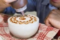 Series of person decorating coffee with art Royalty Free Stock Photo