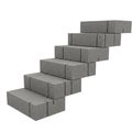 Stacked Grey Concrete Bricks Forming a Staircase on a White Background gray building material Royalty Free Stock Photo