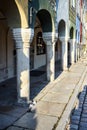 A series of stone columns in the arcades of historic tenement houses on the market square Royalty Free Stock Photo