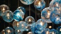 A series of suspended globes made from recycled plastic bottles each one painted and lit from within creating a