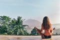 Beautiful girl is meditating on terrace with a stanning view on Royalty Free Stock Photo