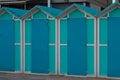 A series of turquoise beach sheds with blue wooden doors in a winter day Italy, Europe Royalty Free Stock Photo