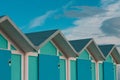 A series of turquoise beach sheds with blue wooden doors in a winter day Italy, Europe Royalty Free Stock Photo