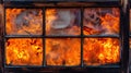 Series of windows showing intense flames, suggesting a fire raging inside Royalty Free Stock Photo