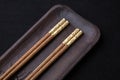 Wooden chopsticks with metal inlay