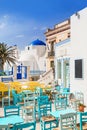 Traditional greek street with cafe tables in Serifos island, Cyclades, Greece. Popular tourist destination in Europe. Royalty Free Stock Photo