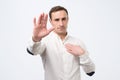 Seriou young man showing stop gesture. Social distance concept Royalty Free Stock Photo