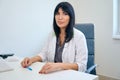 Serious adult european female doctor looking at camera in clinic Royalty Free Stock Photo