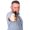 Serious adult man with a beard in a blue bow tie in summer shirt with a firearm in hand in hand aiming at you on an isolated white Royalty Free Stock Photo