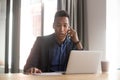 Serious african American boss solve problems over phone Royalty Free Stock Photo