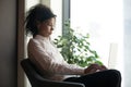 Serious African American businesswoman using laptop in modern office Royalty Free Stock Photo