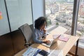 Serious African American businesswoman working using laptop in modern office. Royalty Free Stock Photo