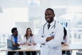 Serious African American doctor portrait. Portrait of medical assistant with stethoscope. Male doctor with a medical