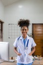 Serious African American doctor working in her office at clinic in white medical gown and stethoscope busy working on computer Royalty Free Stock Photo