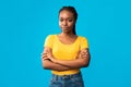 Serious African American Girl Crossing Hands Standing Over Blue Background Royalty Free Stock Photo