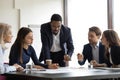 Serious African American team leader talking to employees Royalty Free Stock Photo