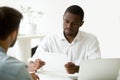 Serious african businessman reading document or considering cont Royalty Free Stock Photo