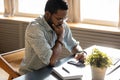 Serious African man read message on smartphone looks focused Royalty Free Stock Photo