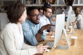 Serious african office worker explaining coworker new online project Royalty Free Stock Photo