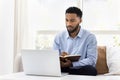 Serious African student man watching online lecture, training seminar Royalty Free Stock Photo