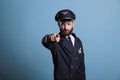 Serious airplane pilot pointing at camera