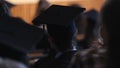 Serious alumnus watching graduation ceremony, hopes for the future, education