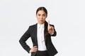 Serious angry asian businesswoman making restriction, give warning sign. Displeased saleswoman showing stop, shaking Royalty Free Stock Photo