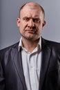 Serious angry emotion man in suit looking. Closeup portrait of actor