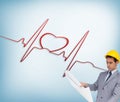 Serious architect with hard hat looking at plans Royalty Free Stock Photo