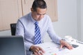 Serious asian business man reading the document in office Royalty Free Stock Photo