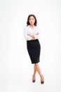 Serious asian businesswoman standing with arms folded and legs crossed Royalty Free Stock Photo