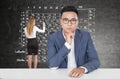 Serious Asian man and chemistry formulas, woman Royalty Free Stock Photo