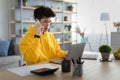 Serious asian man working and talking on phone at home Royalty Free Stock Photo