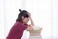 Serious Asian teen girl with eyeglasses pay attention reading book for examination or competition, university student read book at Royalty Free Stock Photo