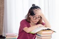 Serious Asian teen girl with eyeglasses pay attention reading book for examination or competition, university student read book at Royalty Free Stock Photo