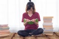 Serious Asian teen girl with eyeglasses pay attention reading book for examination or competition, university student read book at Royalty Free Stock Photo