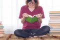 Serious Asian teen girl with eyeglasses pay attention reading book for examination or competition, university student read book at Royalty Free Stock Photo