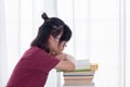 Serious Asian teen girl with eyeglasses pay attention reading book for examination or competition, university student read book at Royalty Free Stock Photo